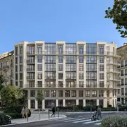 Фасад здания с влияниями стиля Белль Эпок с витринами и балконами.